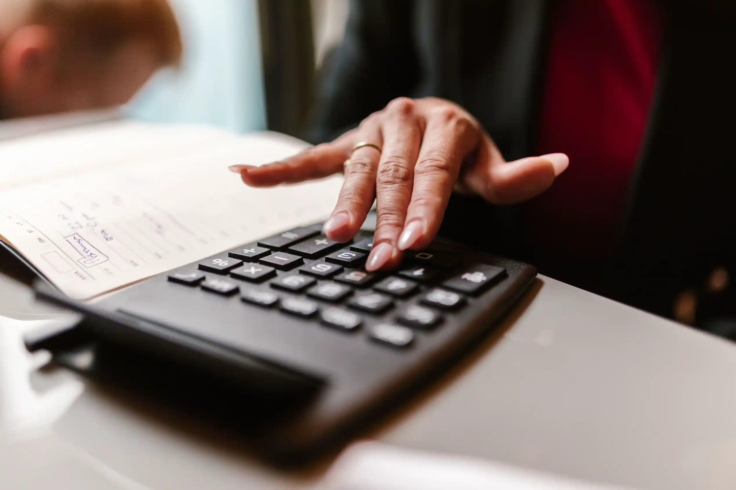 An accountant calculating business taxes with a calculator