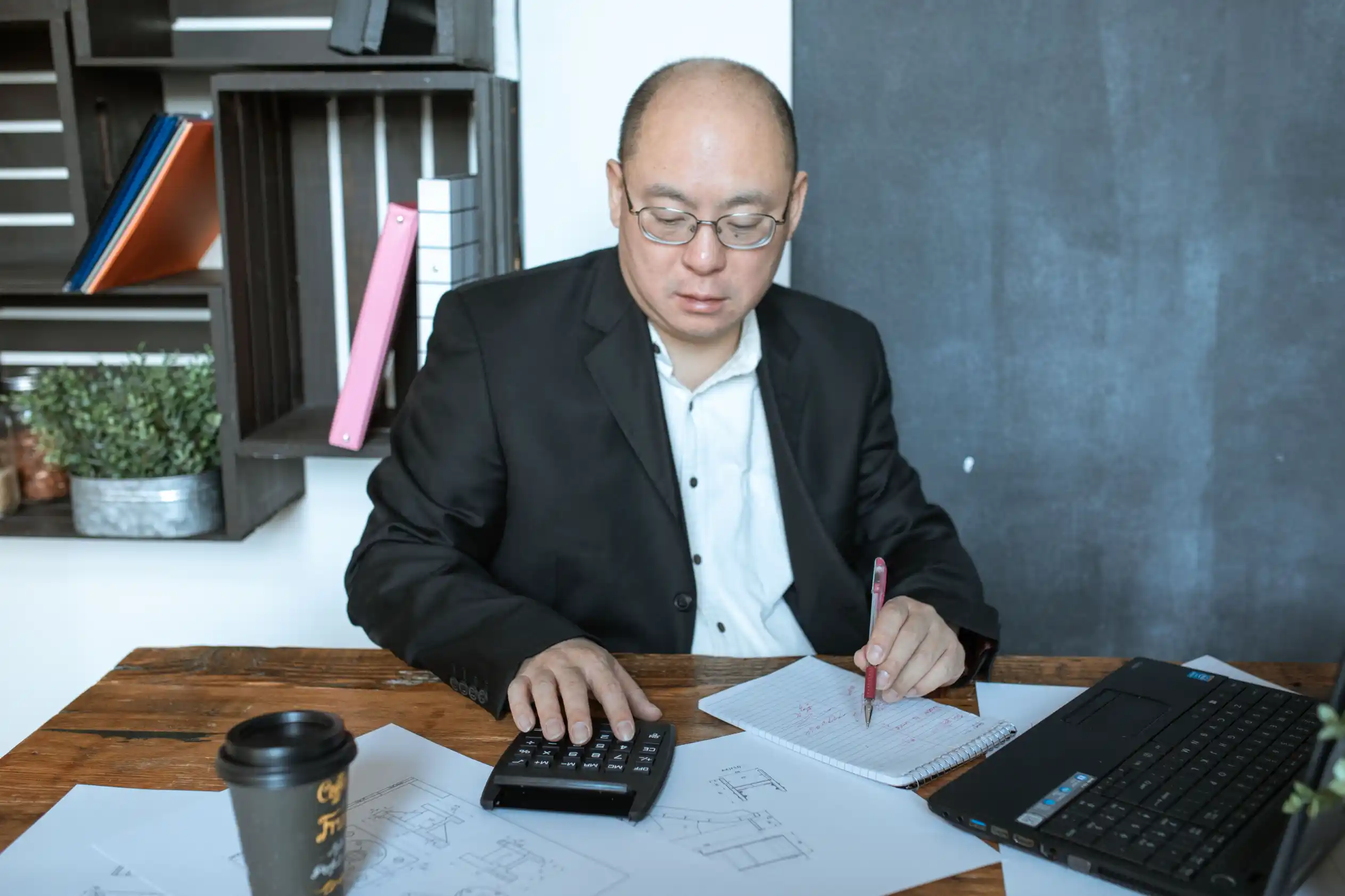 An accountant meeting a client across a desk to discuss their business