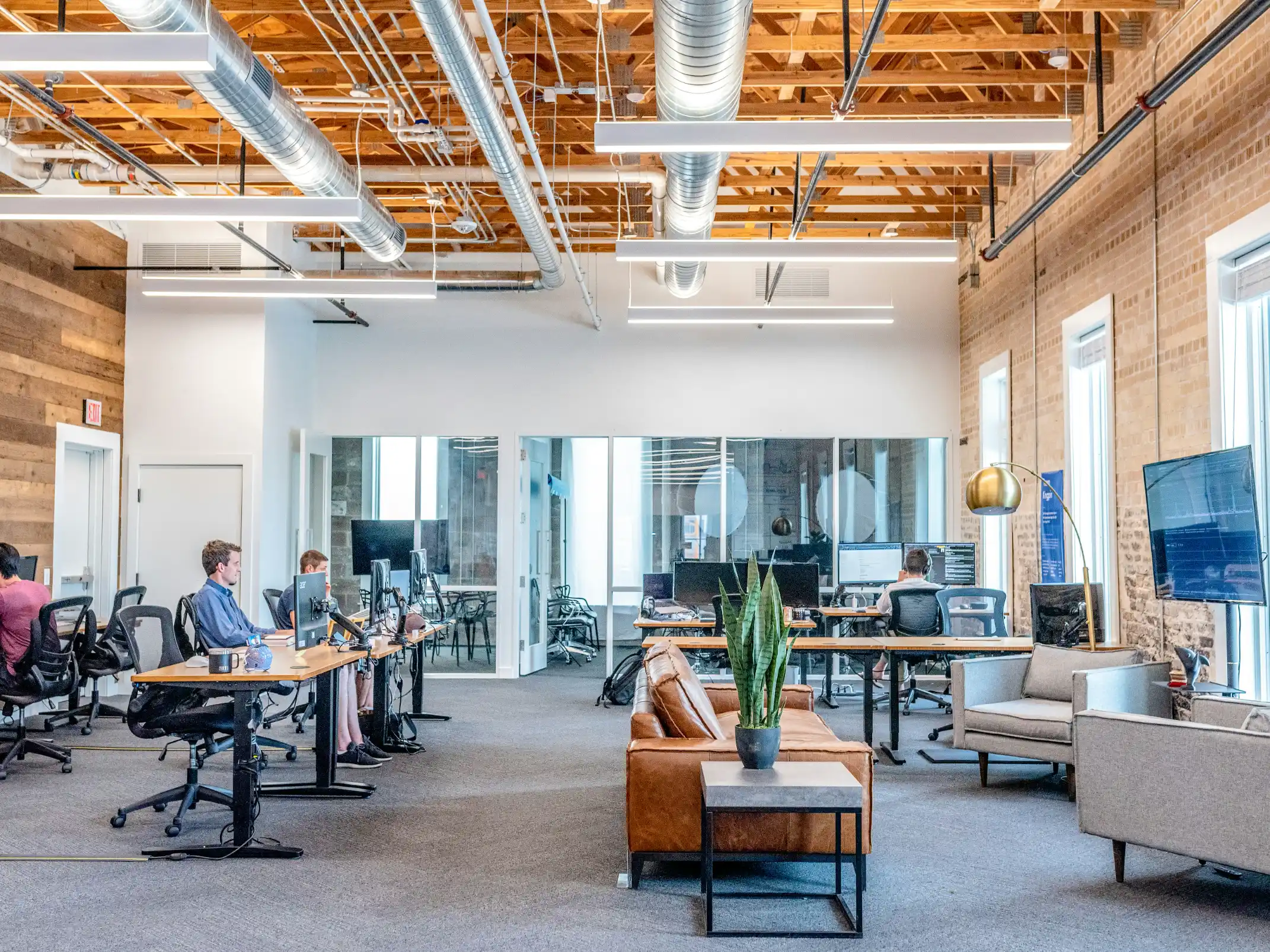 A bright open-plan office with desks and large windows