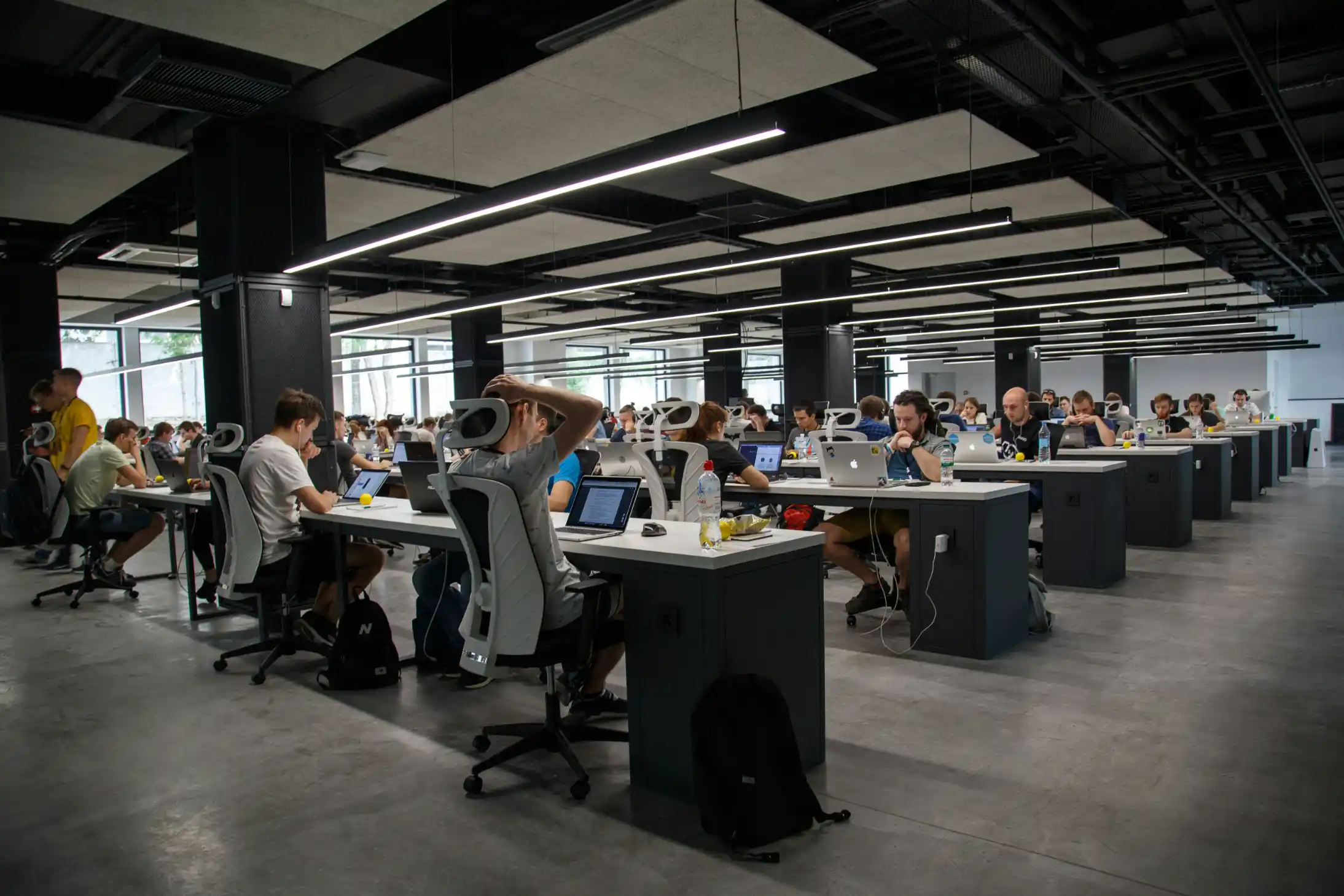 A large open office with staff working at rows of desks