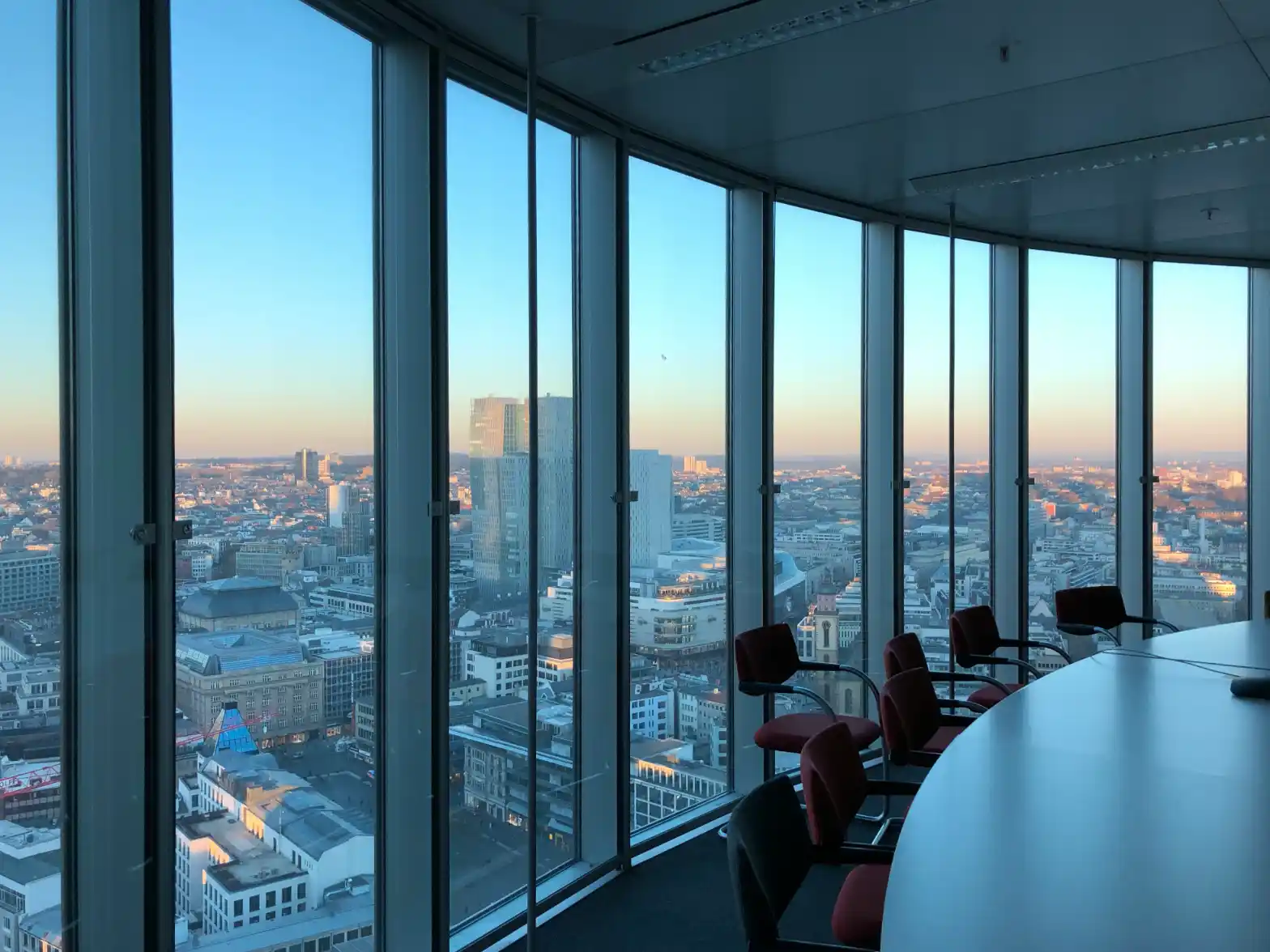 A corporate office with floor-to-ceiling windows overlooking the city