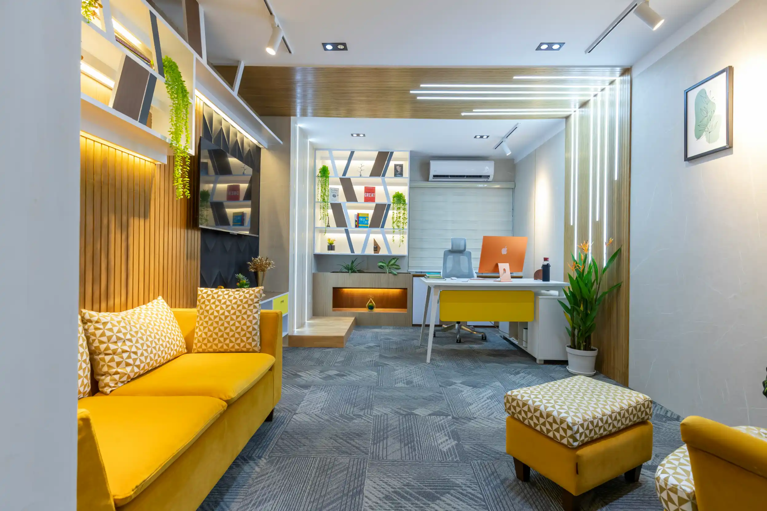 A bright clinic waiting area with a yellow sofa and reception desk