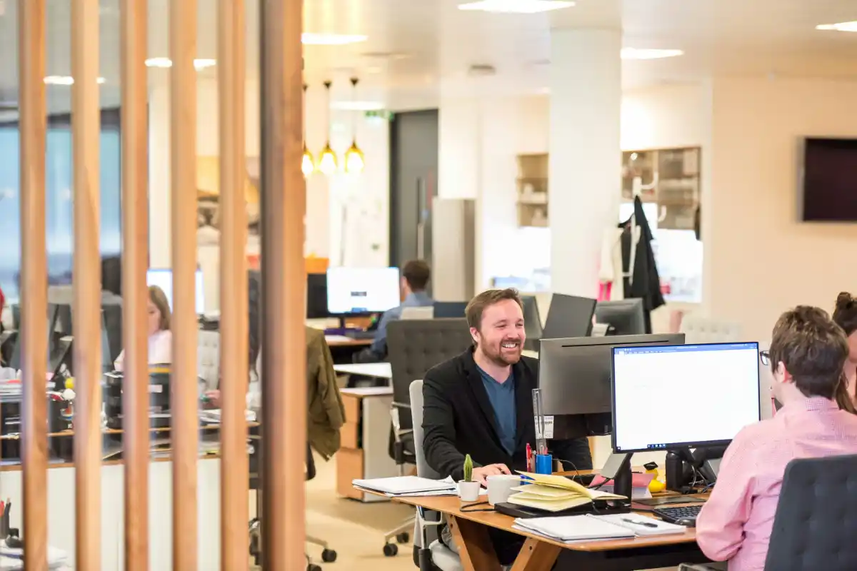 A professional consultant working at a desk in a modern office