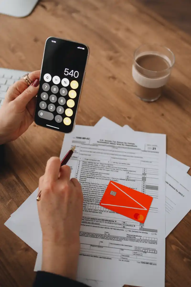 Small business tax paperwork and a calculator on an accountant's desk
